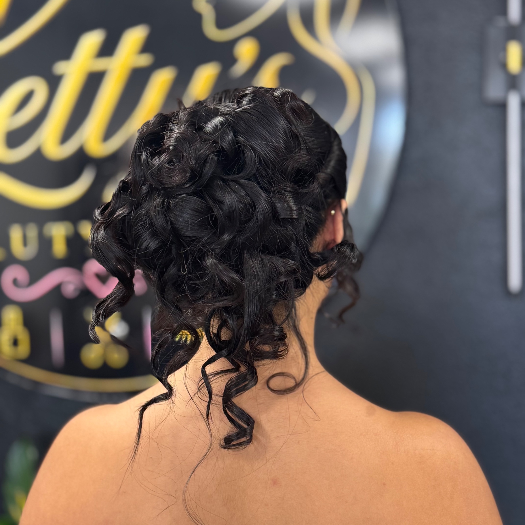 Sculpted dark curly up do
